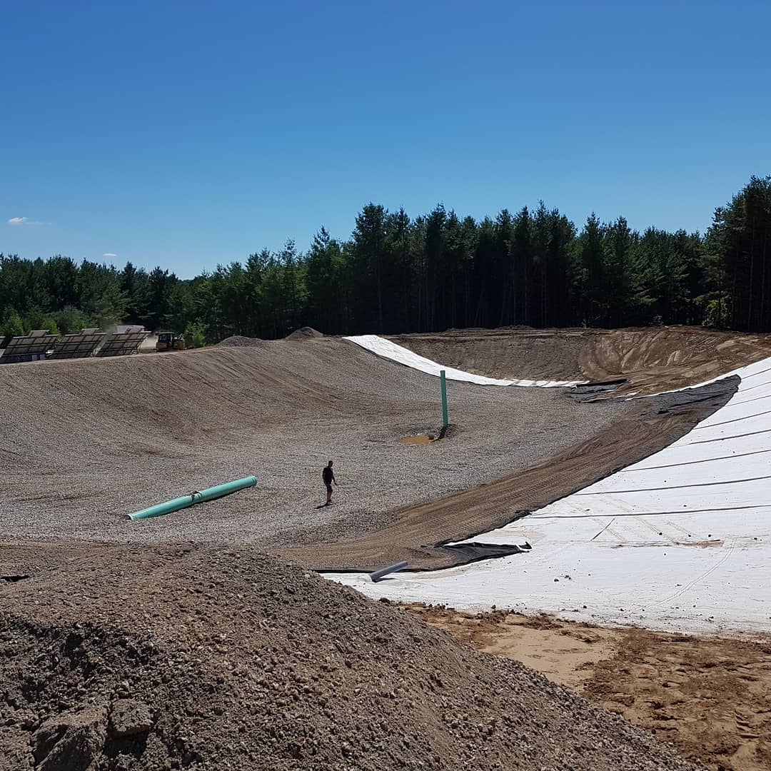 Bentonite clay liner covered for protection during irrigation pond construction in Hamilton