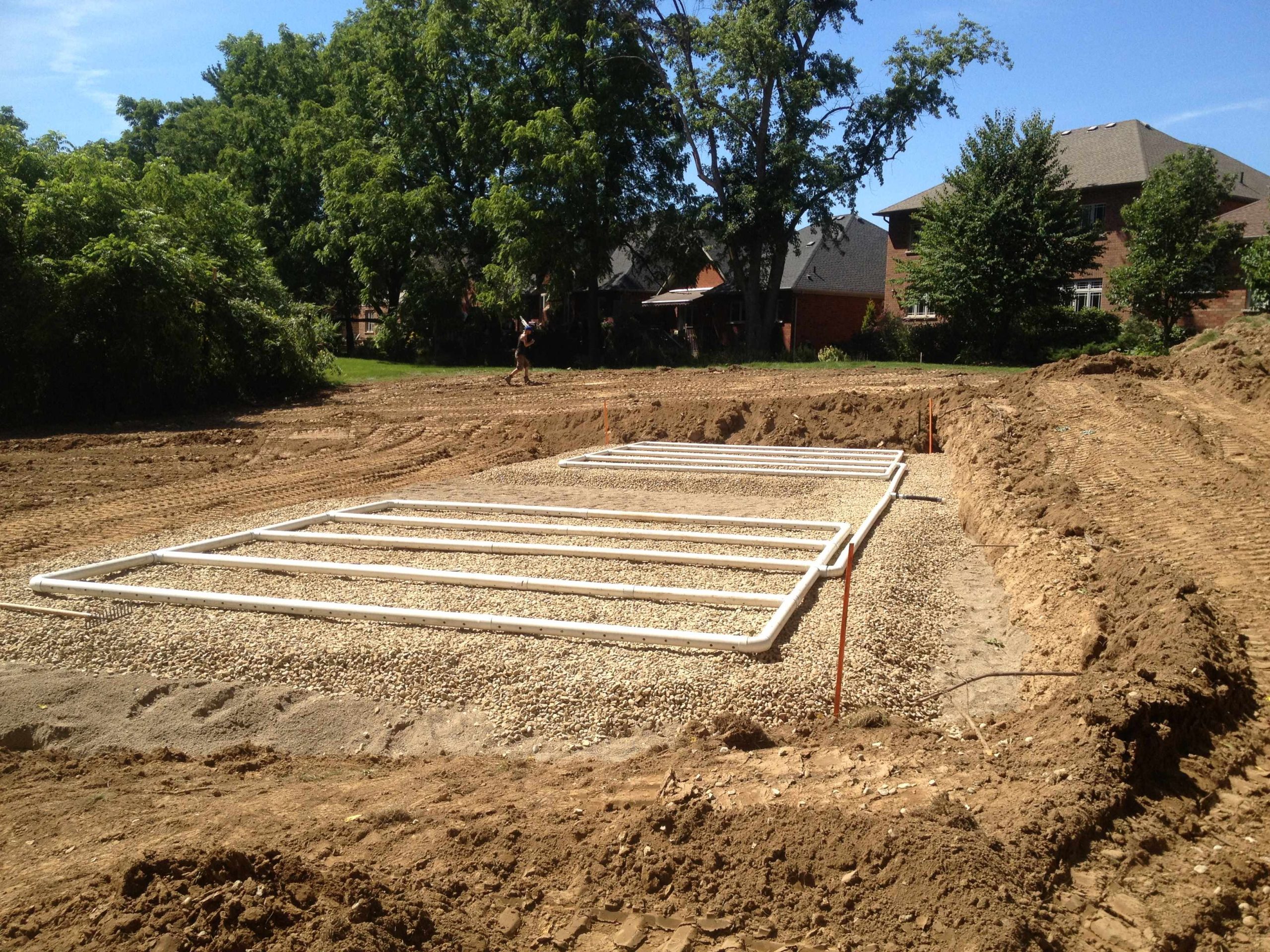 Traditional sand mound filter bed with stone layer and distribution pipes in Ancaster, Ontario