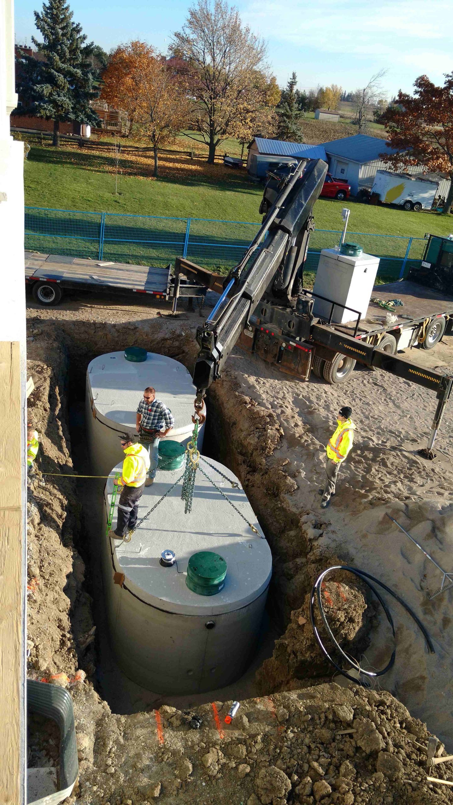 Overhead view of an advanced septic treatment unit installed near a house in Milton, ensuring compliance with regulations.