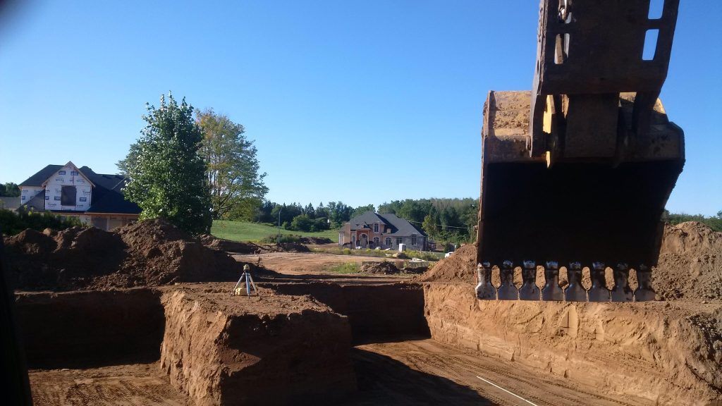 Foundation excavation with straight cut lines in Dundas