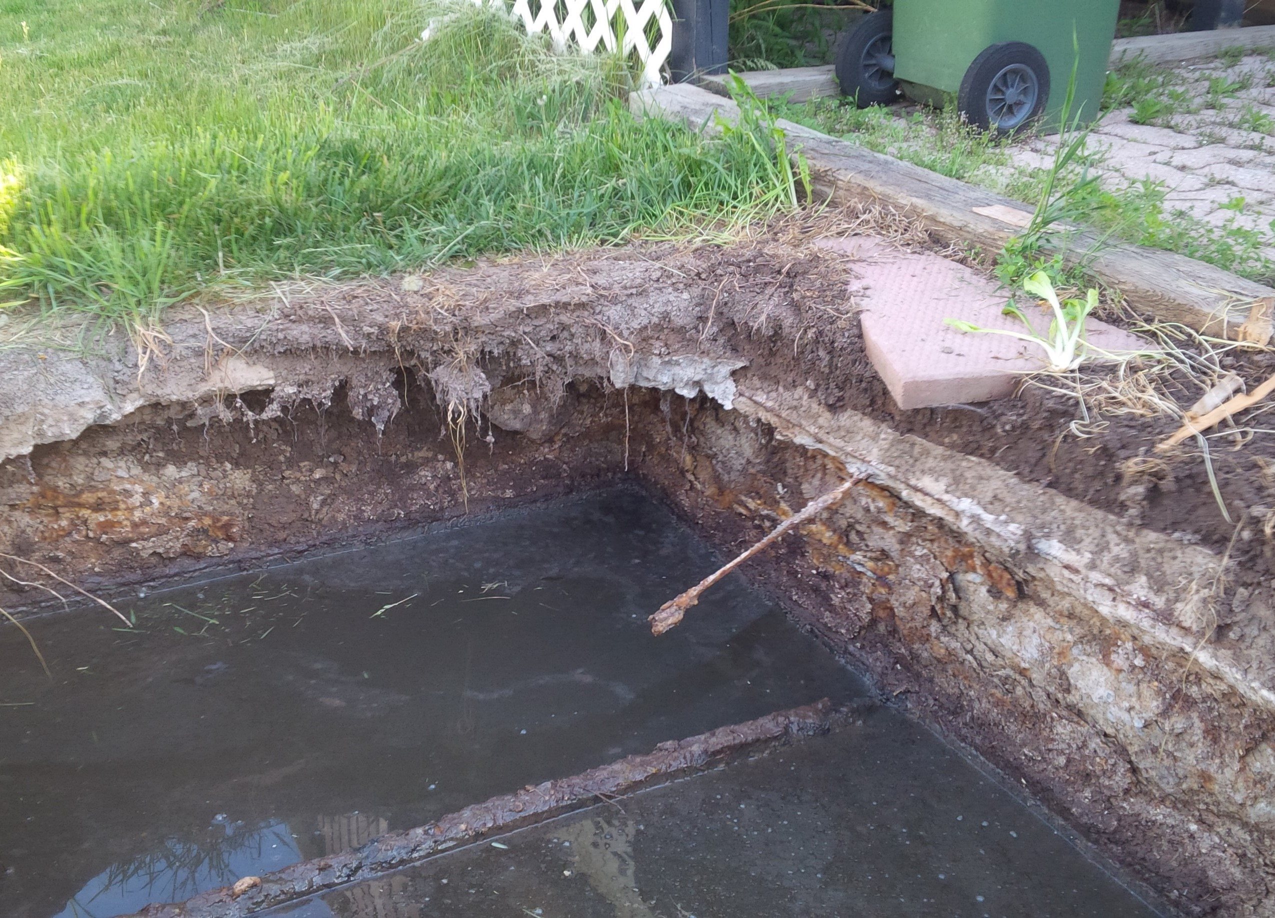 Corrosion of a precast concrete septic tank above the waterline in Flamborough due to septic gases, leading to system failure.