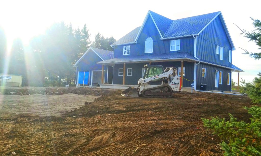 Finished grading around a home after advanced septic construction
