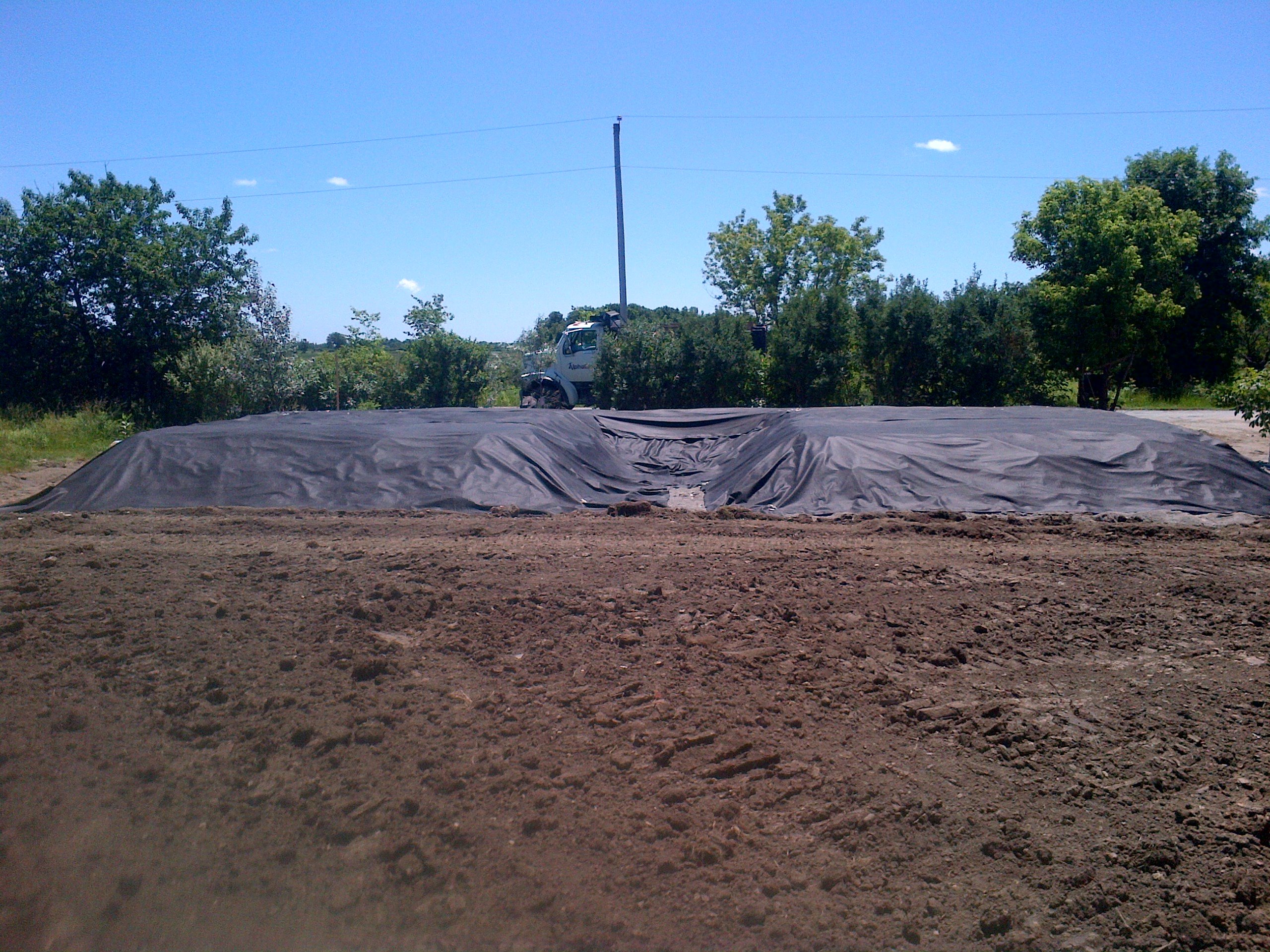 Sand mound filter bed covered with geotextile fabric, ready for topsoil in Haldimand