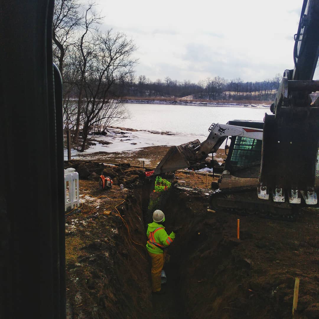 Septic collection lines installed by the river in Haldimand, highlighting Alpha Ex's eco-conscious approach.