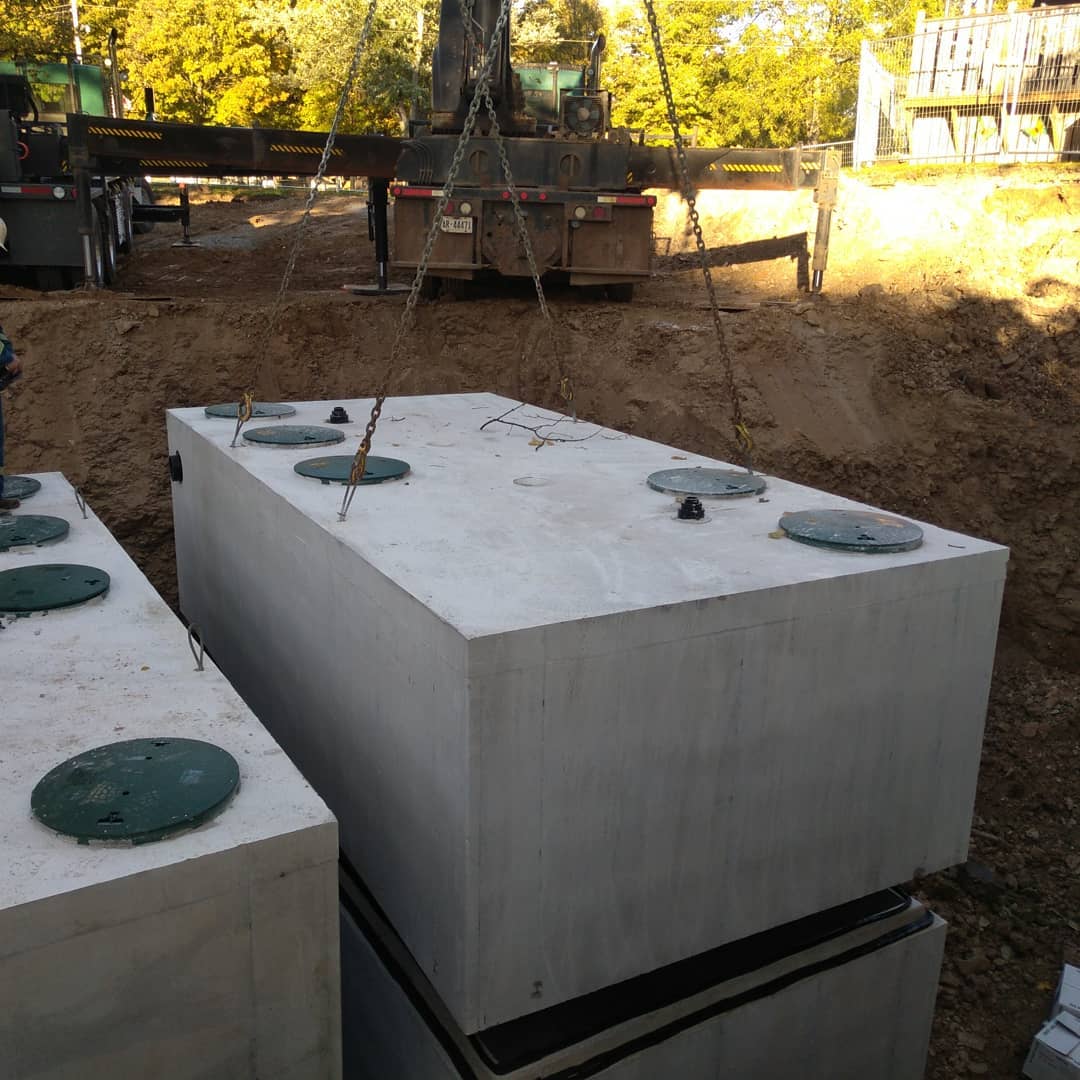 Septic tank being carefully dropped into place in Haldimand by Alpha Ex.