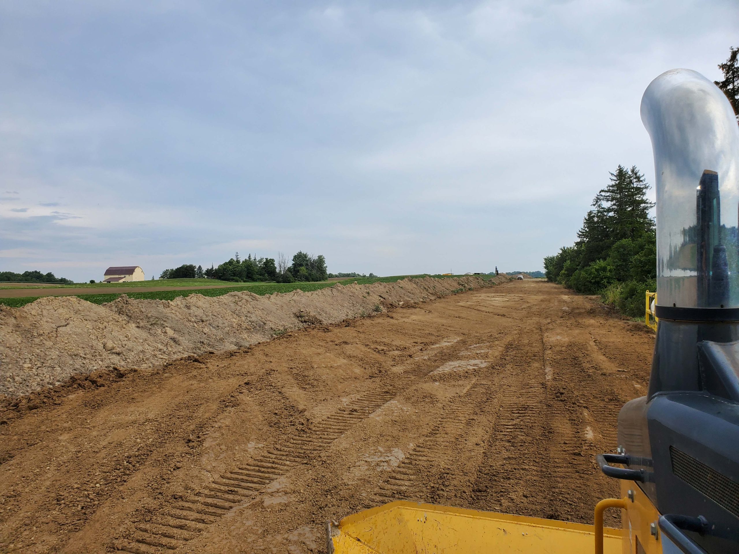 View from the operator's platform of a Deere 550K LGP dozer during land clearing and earthworks in Brant